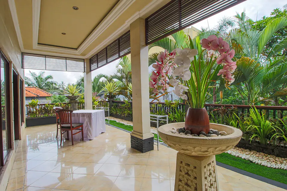Covered terrace surrounded by orchids and tropical plants